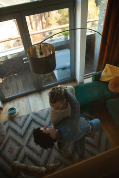 Two Young Multiracial Guys Dancing In Living Room Photographed From Above