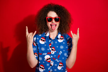 Photo portrait of pretty young girl tongue out rock gesture wear trendy blue print x-mas outfit...