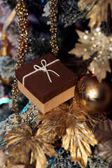 Fototapeta na wymiar Christmas gift or present box, snowy fir tree and holiday decoration.