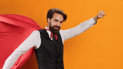 Elegant butler with red cape posing on camera while he acts like superhuman at luxury restaurant,...