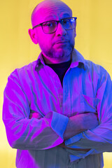 Bald, bearded man wearing prescription glasses