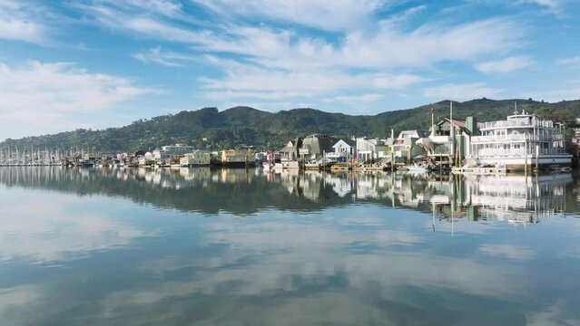 Time lapse of Sausalito houses at the water, San Francisco suburban, California, West coast, USA. Drone shot of Sausalito town surrounded mountains and Pacific ocean. Yachts in marine of Sausalito