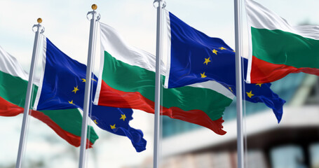 Flags of Bulgaria and the European Union waving in the wind on a clear day