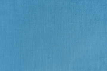 Texture background of blue linen fabric. Textile structure, cloth surface, weaving of natural cotton fabric closeup, backdrop, wallpaper.