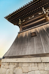 Gently curved wooden wall in a temple in Kyoto, Japan.
Very elaborate roof and wood wall in a...