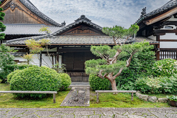 Fototapeta premium Traditional Zen architecture in Japan. Gravel entrance with ornamental trees. 