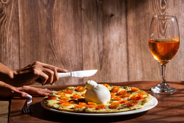 Fresh cheese burrata on pizza served on the table