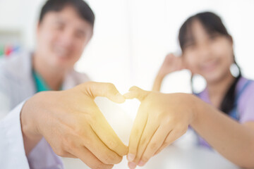 asian children patient and doctor show heart sign with hands together, happiness and relationship...