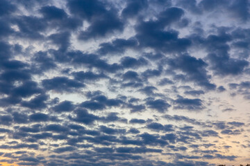 Fototapeta premium Wonderful idyllic sky with gray clouds and orange tones