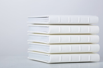 Stack of photo books with cover of genuine leather. Wedding photobooks in white leather binding....