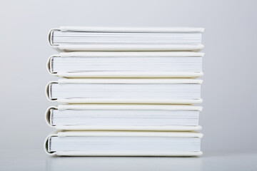 Stack of photo books with cover of genuine leather. Wedding photobooks in white leather binding....