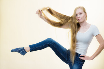 Blonde girl brushing her long hair