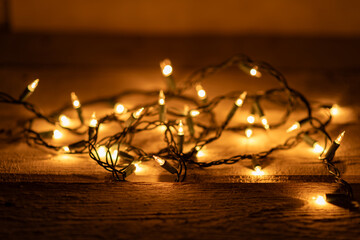 Warm white lights string with a gold glow and a shallow depth of field