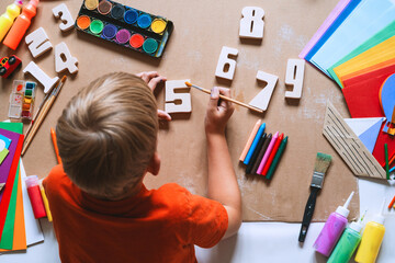 Child drawing and making crafts in school or daycare.