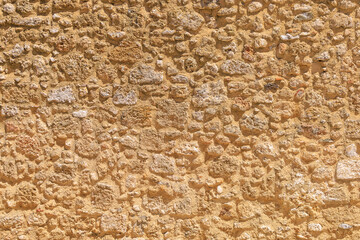 Rough textured surface of the wall of an ancient city. Background with selective focus and copy...