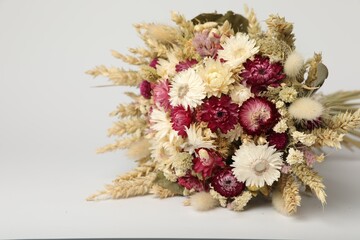 Beautiful bouquet of dry flowers on white background, space for text