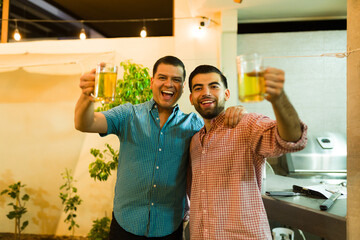 Portrait of handsome latin men enjoying drinking beer
