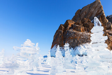Baikal Lake on sunny February day. Traditional ice pyramids made of transparent ice floes, built by...