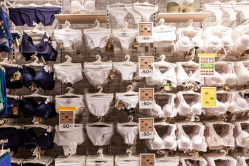 A large assortment of women's panties in a lingerie store during discounts and sales. Front view.