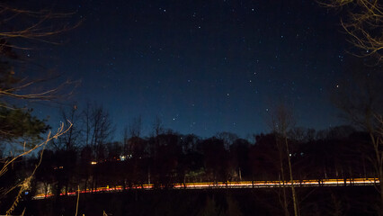 Fototapeta premium Vehicle Light Streaks by a Side of a Hill at Night, Baltic, Ohio