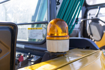 Yellow revolving lights installed on the back of construction equipment