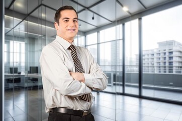 Happy confident business man in office hall