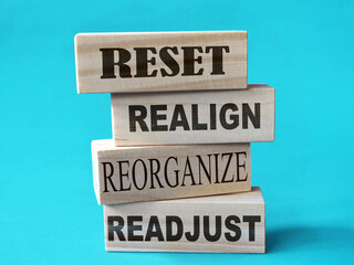 Reset realign readjust, word text written on wooden block, life business term