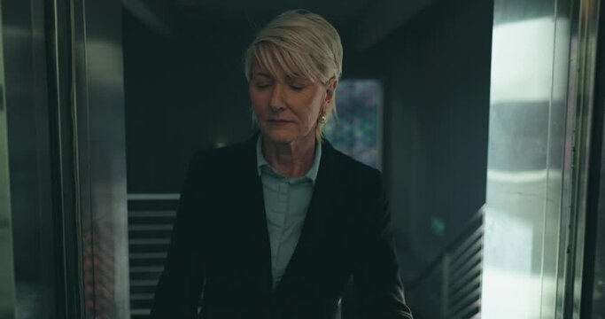 Senior business woman, elevator and office with thinking, click button or choice for floor. Mature corporate executive, hotel and decision in lift, building or idea at finance company, agency or job