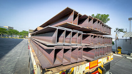 Fototapeta na wymiar Metal profiled steel beams are packed at the metal products warehouse, H-beam steel and Wi-Frank steel. For large structures or building columns