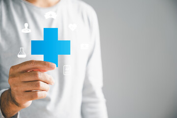 Isolated, a male hand holds a plus icon, representing addition of positives, benefits, personal growth, health insurance, and growth. Portrays innovation in health care and technology.