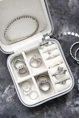 Organizer with stylish jewelry on dark grunge background