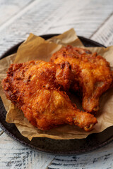 Crispy chicken thighs fried on a wooden table