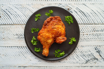 Crispy chicken thighs fried on a wooden table