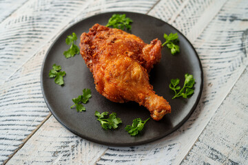 Crispy chicken thighs fried on a wooden table