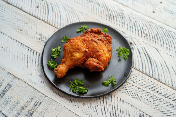 Crispy chicken thighs fried on a wooden table