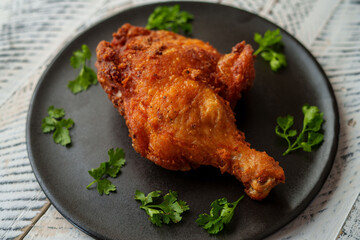 Crispy chicken thighs fried on a wooden table