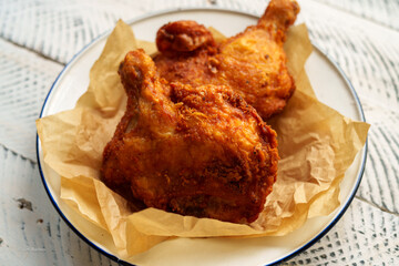 Crispy chicken thighs fried on a wooden table