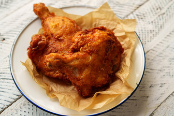 Crispy chicken thighs fried on a wooden table