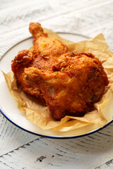 Crispy chicken thighs fried on a wooden table
