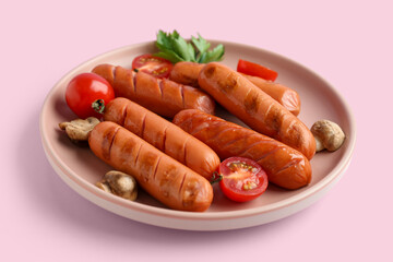 Plate with tasty grilled sausages on pink background