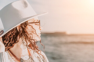 Portrait of a curly haired woman in a white hat and glasses on t
