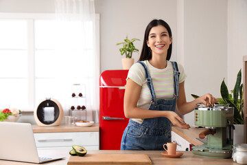 Young woman with coffee machine in kitchen