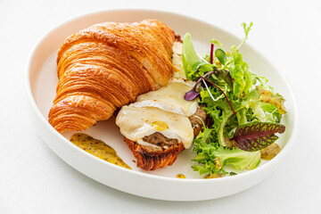croissant with cheese and salad