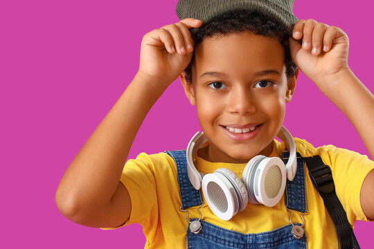 African-American little boy in hat on purple background, closeup
