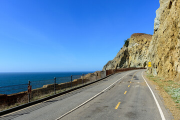 Scenic bicycle and pedestrian Devils Slide trail, a picturesque winding mountain road, with steep cliffs on one side and the ocean on another side