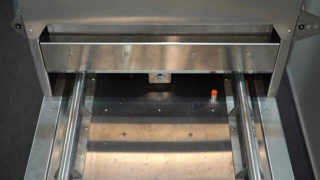 Production of plastic packages, industrial background. Media. Close up of conveyor belt with plastic small boxes.