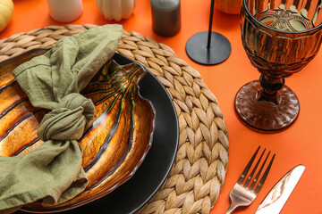 Stylish table setting on orange background