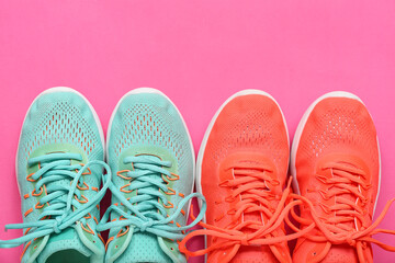 Different stylish sneakers on pink background