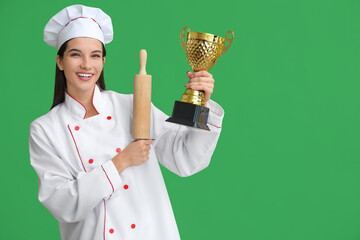 Female chef with gold cup and rolling pin on green background