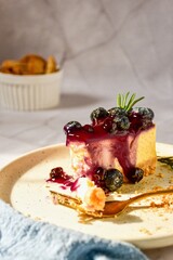 Blueberry cheese cake Place on a cream-colored plate. white background